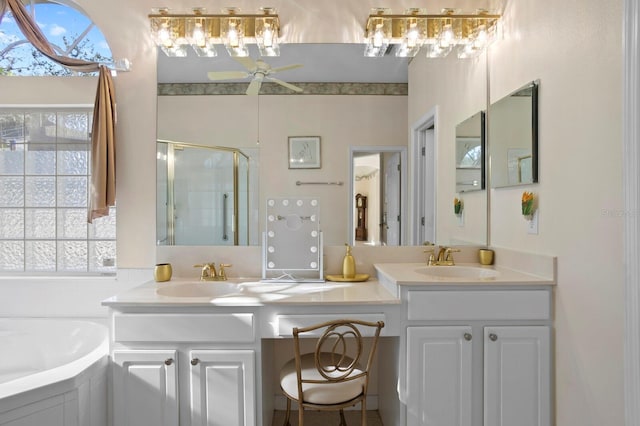 bathroom with ceiling fan, vanity, and separate shower and tub