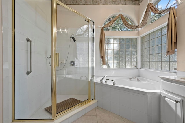 bathroom featuring tile patterned floors, shower with separate bathtub, and vanity