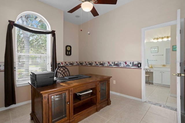 tiled office featuring ceiling fan and sink