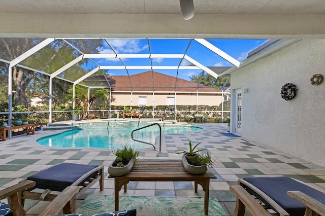 view of swimming pool featuring an in ground hot tub, glass enclosure, and a patio area