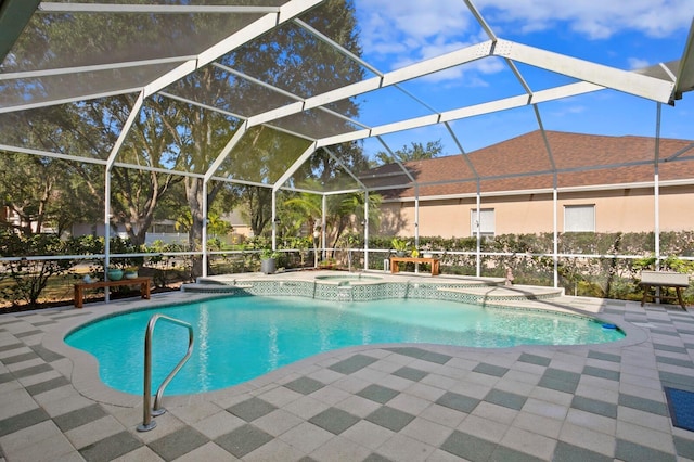 view of pool with an in ground hot tub, a patio, and glass enclosure