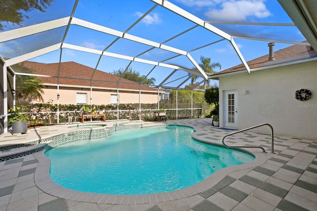 view of pool with an in ground hot tub, glass enclosure, and a patio area