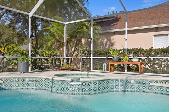 view of swimming pool with a lanai, a patio, and an in ground hot tub