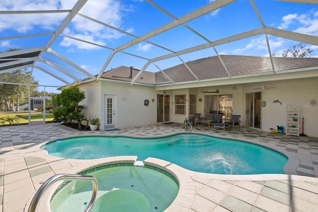 view of swimming pool with an in ground hot tub, a lanai, ceiling fan, and a patio area