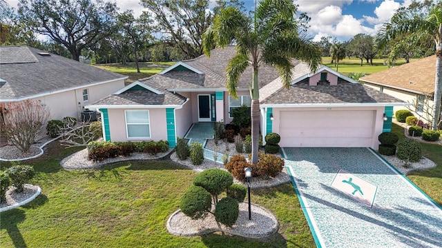 single story home featuring a front lawn and a garage