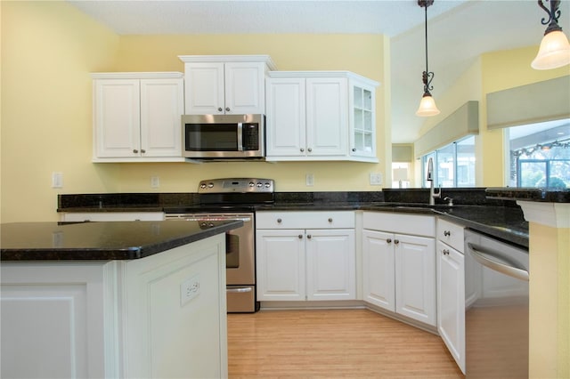 kitchen with white cabinetry, sink, pendant lighting, and appliances with stainless steel finishes