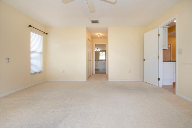 carpeted empty room with plenty of natural light and ceiling fan