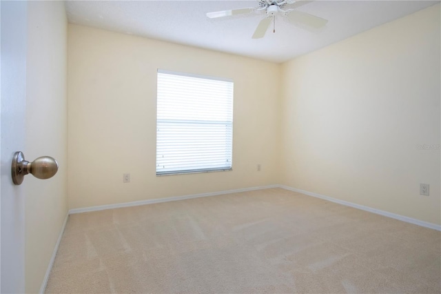 unfurnished room featuring light colored carpet and ceiling fan