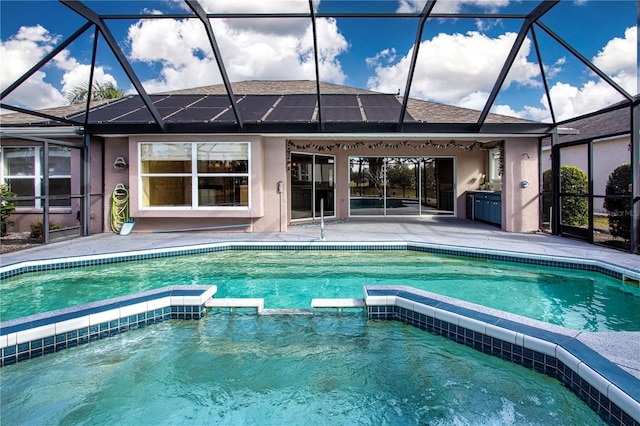 view of swimming pool featuring a patio and a lanai