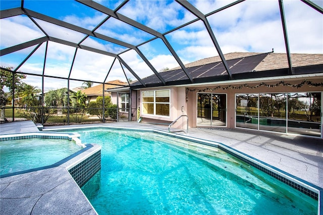 view of swimming pool featuring a lanai and a patio