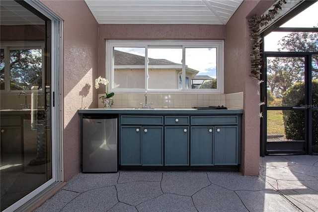 unfurnished sunroom featuring sink