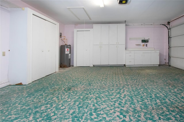 garage featuring a garage door opener and electric water heater