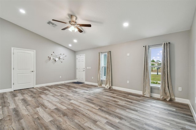 spare room featuring ceiling fan, light hardwood / wood-style floors, and lofted ceiling