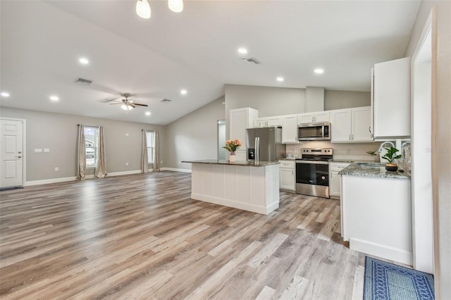 kitchen featuring white cabinets, sink, ceiling fan, appliances with stainless steel finishes, and a kitchen island