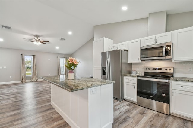 kitchen with white cabinets, stainless steel appliances, and stone counters