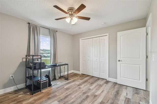 office area featuring ceiling fan, a textured ceiling, and light wood-type flooring