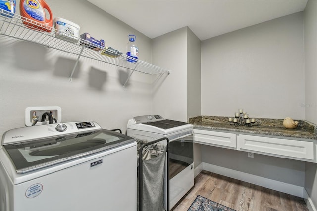 washroom with light wood-type flooring and separate washer and dryer