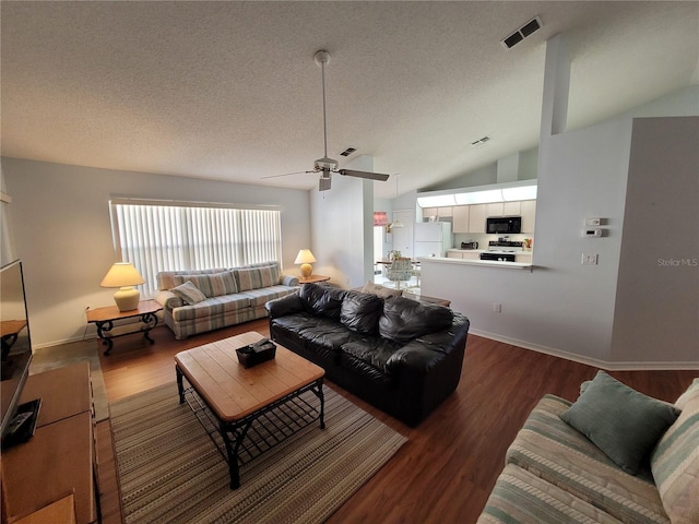 living room featuring dark hardwood / wood-style floors, ceiling fan, a textured ceiling, and vaulted ceiling