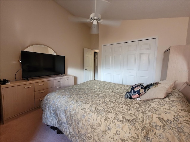 bedroom with a closet, vaulted ceiling, ceiling fan, and light colored carpet