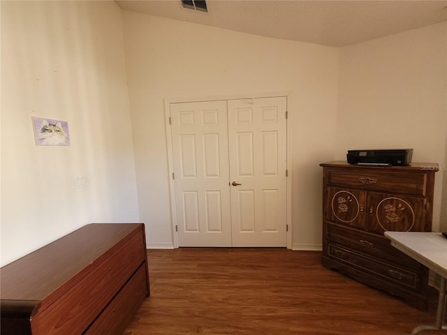 bedroom featuring a closet and dark wood-type flooring