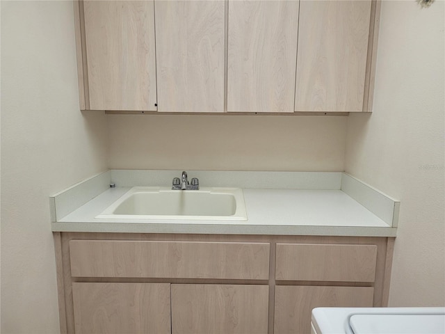 clothes washing area featuring sink