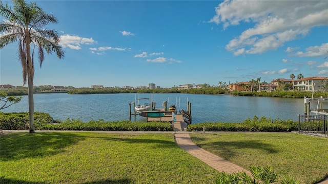 dock area with a yard and a water view