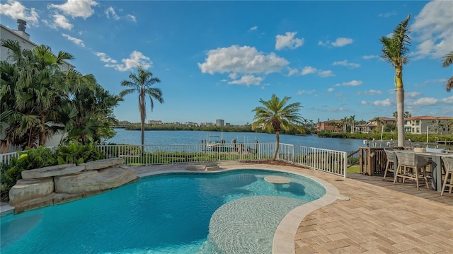 view of swimming pool featuring a water view and a patio