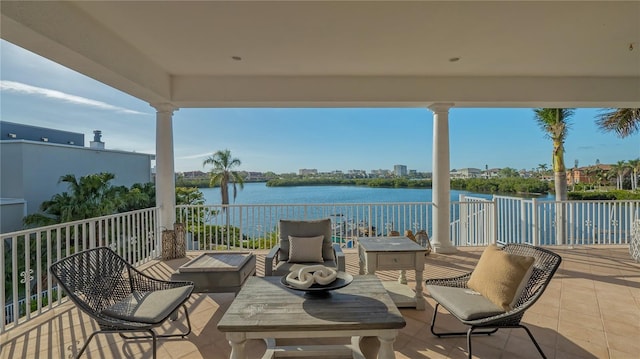 view of patio featuring a balcony and a water view