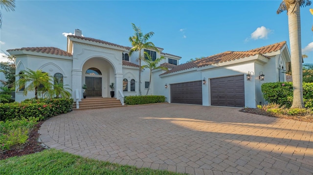 mediterranean / spanish house featuring a garage