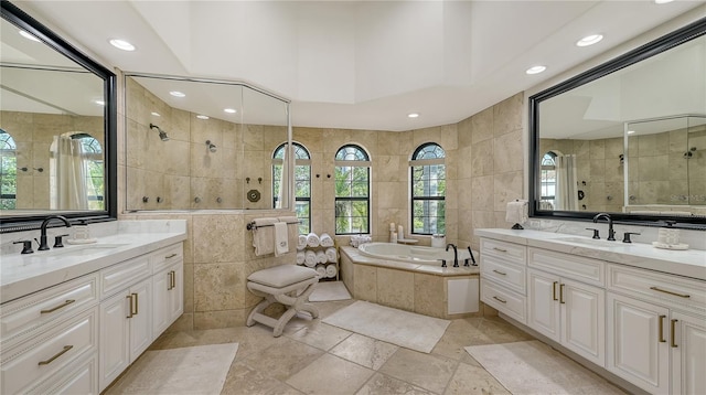 bathroom with plus walk in shower, vanity, and tile walls