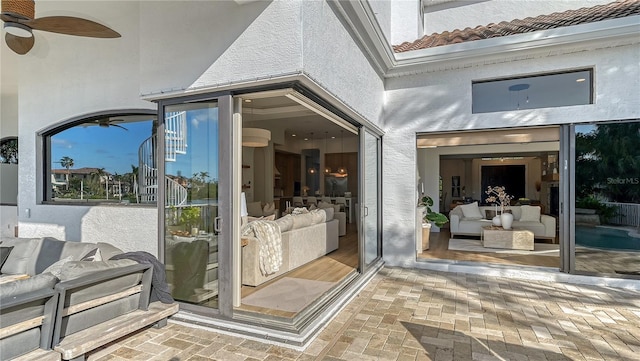 doorway to property with a patio and ceiling fan