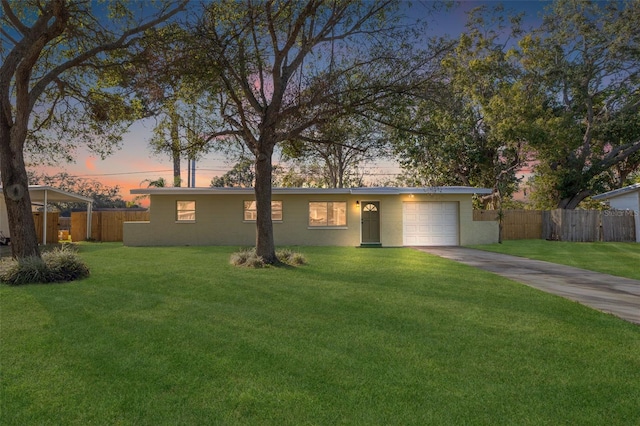 single story home with a lawn and a garage