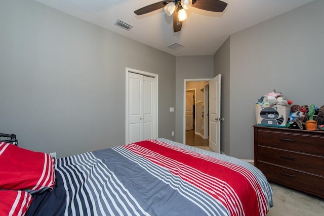 carpeted bedroom featuring ceiling fan and a closet