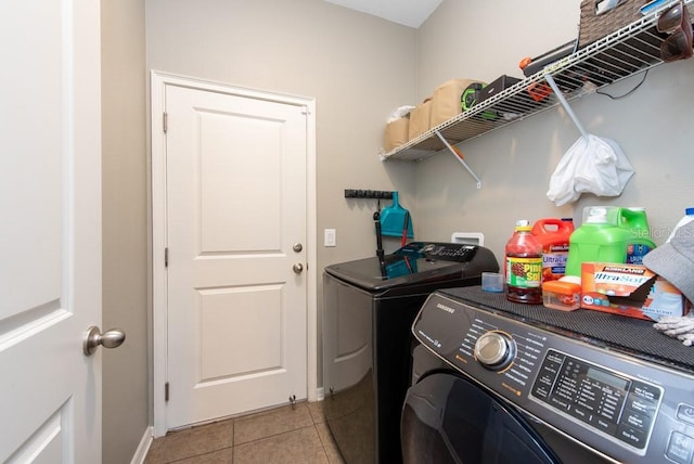 laundry room featuring light tile patterned floors and separate washer and dryer