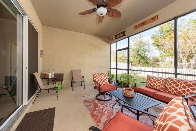 sunroom / solarium featuring ceiling fan