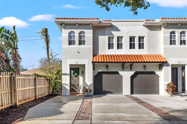 mediterranean / spanish-style house with a garage