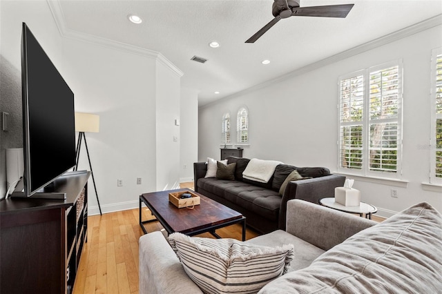 living room featuring light hardwood / wood-style flooring, ceiling fan, and ornamental molding