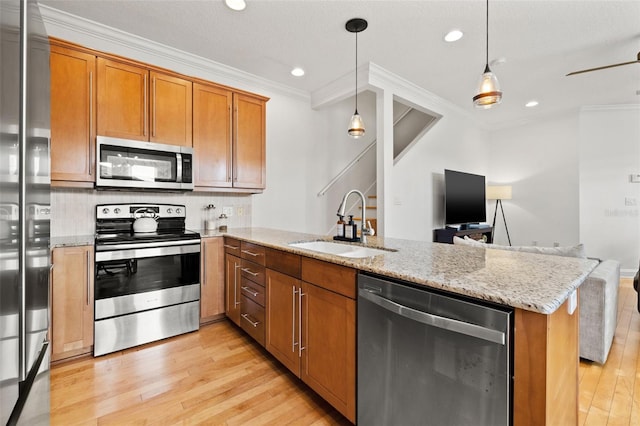 kitchen with sink, hanging light fixtures, stainless steel appliances, crown molding, and decorative backsplash