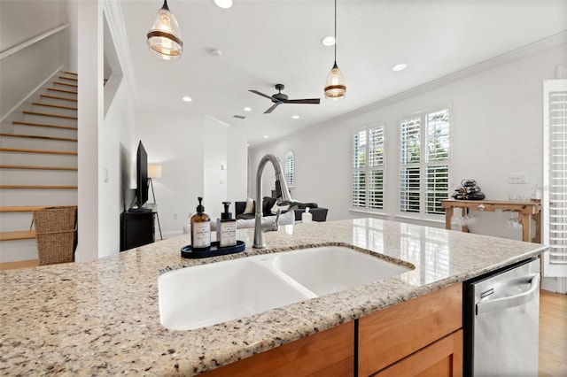 kitchen featuring pendant lighting, sink, stainless steel dishwasher, ceiling fan, and ornamental molding