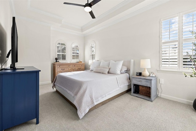 bedroom with ceiling fan, a raised ceiling, ornamental molding, and carpet floors