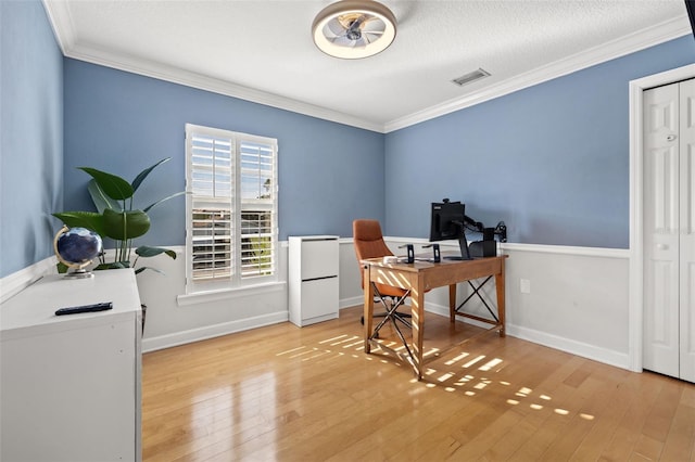 office space with light hardwood / wood-style floors and ornamental molding