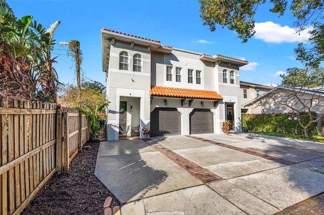 mediterranean / spanish-style house with a garage