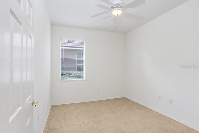 spare room featuring ceiling fan and light tile patterned flooring