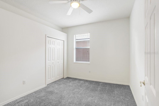 spare room featuring carpet flooring and ceiling fan