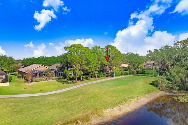 surrounding community with a water view and a lawn