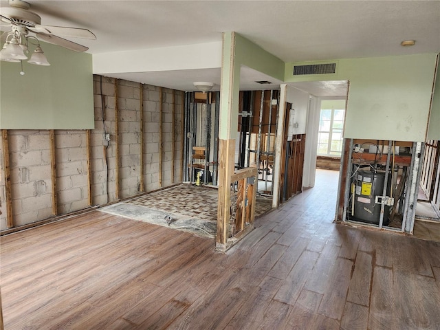 interior space with ceiling fan and wood-type flooring