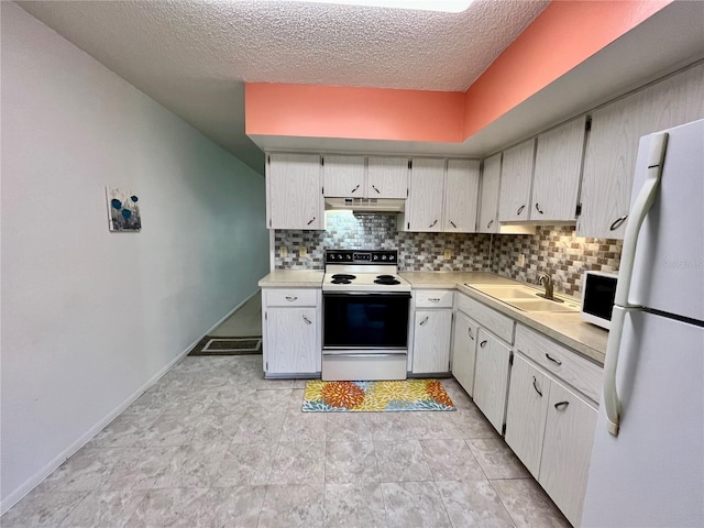 kitchen featuring a textured ceiling, decorative backsplash, sink, and white appliances