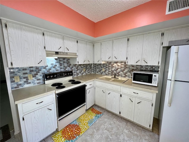 kitchen with sink, tasteful backsplash, a textured ceiling, white appliances, and white cabinets