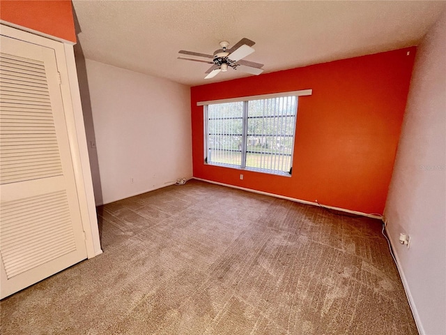 unfurnished bedroom with carpet flooring, a textured ceiling, and ceiling fan