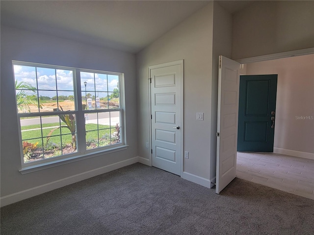 unfurnished bedroom featuring carpet floors and lofted ceiling